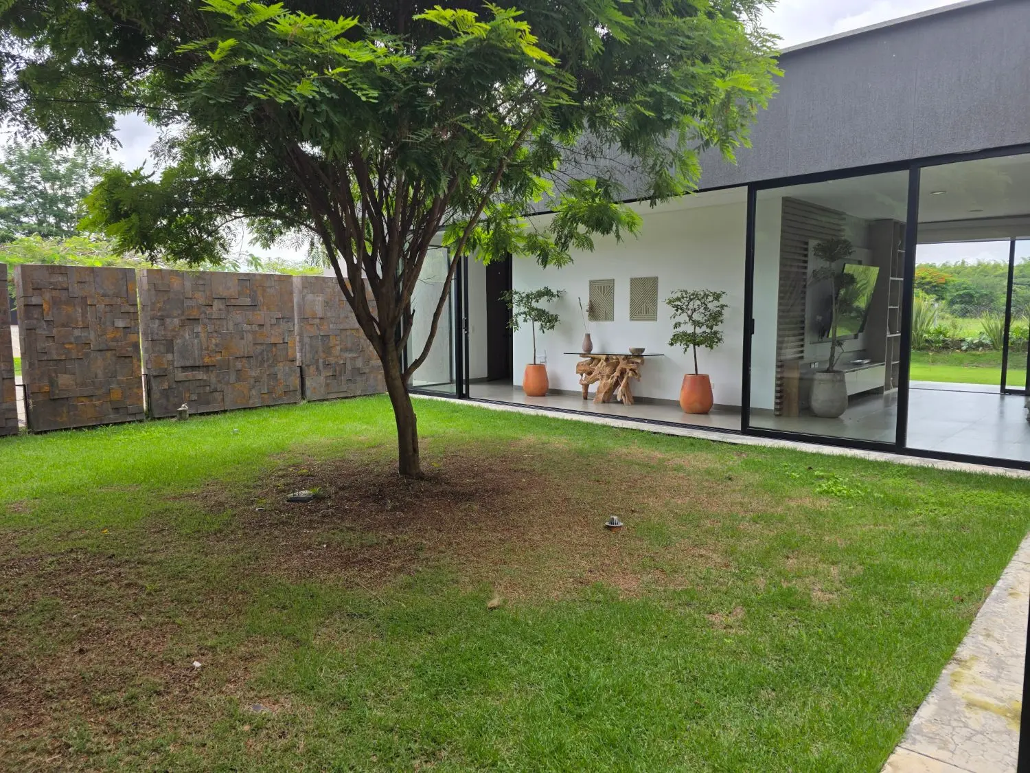 Corredor cubierto que conduce al patio central con su árbol